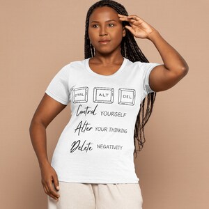 Könnte beinhalten: Weißes T-Shirt mit einer Grafik von Computertasten, auf denen "Kontrolle dich selbst, ändere dein Denken, lösche die Negativität" steht.