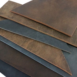 May include: A stack of leather pieces in various shades of brown and blue. The leather is textured and has a rustic look.