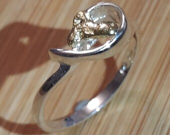 Silver ring with  a gold nugget .