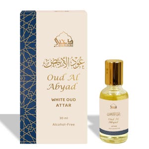 May include: A perfume bottle and box set. The bottle has a gold cap and a label that reads "Oud Al Abyad". The box is white with gold accents and the text "Oud Al Abyad" and "White Oud Attar". The bottle contains 30 ml of alcohol-free perfume.