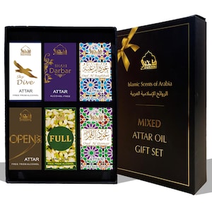May include: A black gift box containing six rectangular attar oil bottles with labels featuring various designs, including a bird, floral patterns, and geometric motifs. The box lid displays the text Dukhni Islamic Scents of Arabia Mixed Attar Oil Gift Set.