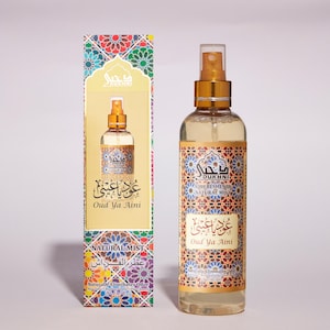 May include: A gold and white bottle of Oud Ya Aini air freshener with a spray nozzle. The bottle is labeled with Arabic text and the words "Air Freshener" and "Natural Mist".