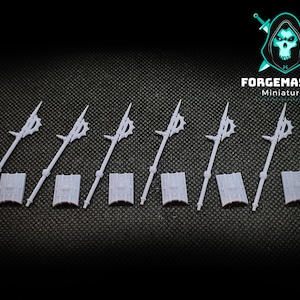 May include: Six white plastic miniature spears with shields. The spears have a pointed tip and a decorative design at the top. The shields are rectangular and have a raised design in the center.