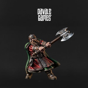 May include: A miniature figurine of a warrior in a red and green tunic, holding a double-bladed axe. The figure has a long, brown beard and is wearing a helmet. The Davale Games logo is in the top left corner.