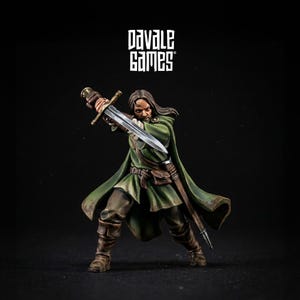 May include: A miniature warrior figure in a green cloak, holding a sword. The figure is in a dynamic pose, with the sword raised. The figure is wearing brown boots and a belt. The text "Davale Games" is in the upper left corner.