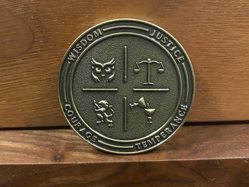 May include: A round, bronze-colored coin with four sections. Each section features a symbol and a word: Wisdom (an owl), Justice (scales), Courage (a lion), and Temperance (a cup).
