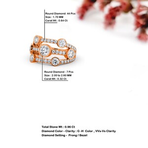May include: A rose gold ring with a multi-row design featuring round diamonds. The ring has a total of 44 round diamonds with a total carat weight of 0.96 carats. The diamonds are set in a prong and bezel setting. The diamonds are G-H color and VVS-Vs clarity.