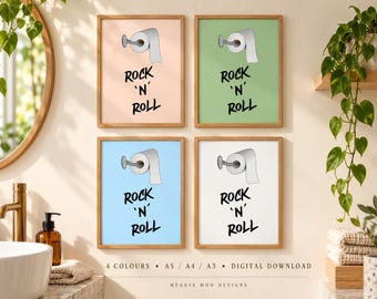 May include: Four framed wall art prints featuring a toilet paper roll illustration and the black text ROCK 'N' ROLL. The prints come in peach, green, light blue, and white backgrounds, each displayed in a simple wooden frame for bathroom decor.