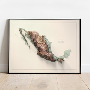 May include: Framed topographical map of Mexico, featuring a 3D relief in shades of brown and green. The map is set against a cream-colored background, enclosed in a black frame. The map includes text indicating elevation and location.
