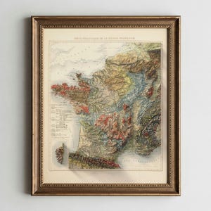 May include: Framed vintage geological map of France, featuring a detailed relief and color-coded representation of the country's terrain. The map is encased in a gold-toned wooden frame, adding a classic aesthetic.