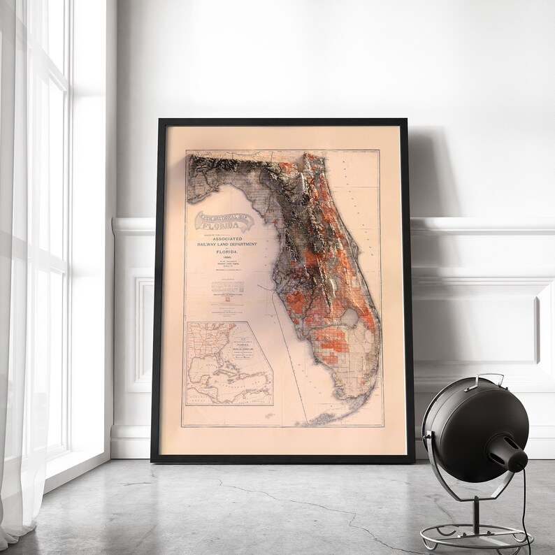 May include: A vintage map of Florida, printed on cream paper and framed in black. The map shows the state's counties and major cities, with a title that reads "Associated Railway Land Department Florida 1908".