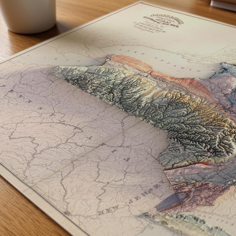 May include: A detailed, vintage map of the northeastern United States, featuring a 3D topographic relief. The map displays states like New York and New Jersey, with shaded relief highlighting the mountainous terrain. The color palette includes beige, brown, and green.