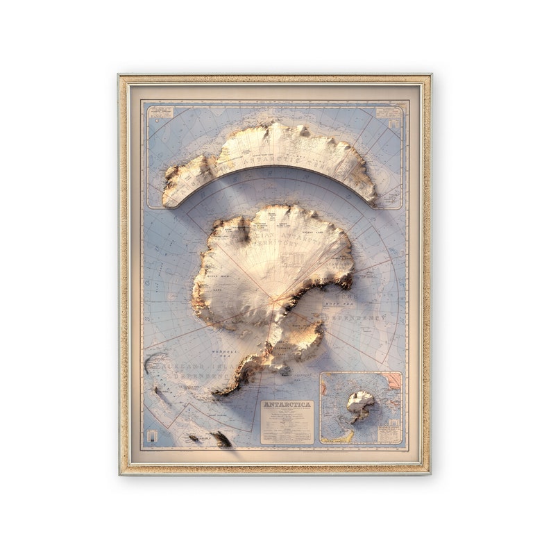 May include: A vintage-style map of Antarctica in a gold frame. The map shows the continent in relief, with mountains and glaciers depicted in brown and white. The map is surrounded by a blue ocean, with islands and other landmasses shown in green. The map is titled "Antarctica" in the lower right corner.