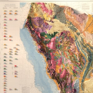May include: A vintage geological map of California, showing different rock formations and geological features in various colours. The map is detailed and includes a key with explanations of the different rock types.