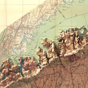 May include: A vintage map of Long Island, New York, with a detailed depiction of the coastline and surrounding areas. The map features a green and brown color scheme with a raised relief effect, highlighting the topography of the region. The map includes various geographical features, such as rivers, lakes, and towns, with labels indicating their names.