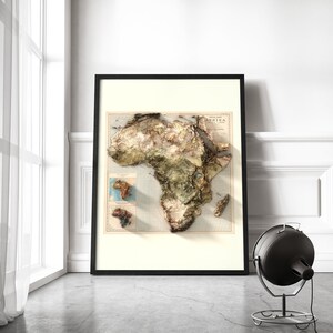 May include: A framed vintage map of Africa with a 3D embossed effect. The map is in shades of brown, green, and blue, with a title that reads "Special Map of Africa".