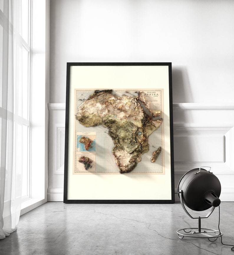 May include: A framed vintage map of Africa with a 3D embossed effect. The map is in shades of brown, green, and blue, with a title that reads "Special Map of Africa".