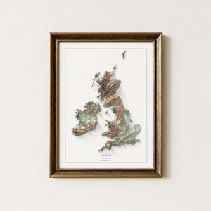 May include: Framed relief map of the British Isles, featuring detailed topographical features in shades of brown and green. The map is set against a white background and encased in a gold-toned wooden frame, creating a classic aesthetic.