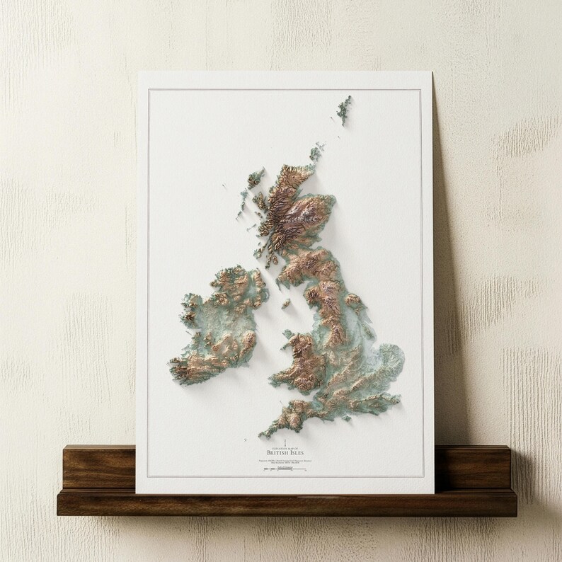 May include: A framed 3D relief map of the British Isles, showcasing the topography in shades of brown and green. The map is set against a white background and mounted on a dark wooden shelf. The title "British Isles" is visible.