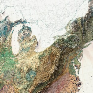 May include: A detailed 3D relief map of the northeastern United States, showcasing the topography with varying shades of green, brown, and blue. The map highlights the Great Lakes and the Appalachian Mountains, with a vintage, textured appearance.