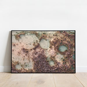 May include: Abstract art print featuring a textured, mottled surface with shades of pink, brown, green, and white. The surface resembles a close-up of the moon's surface.