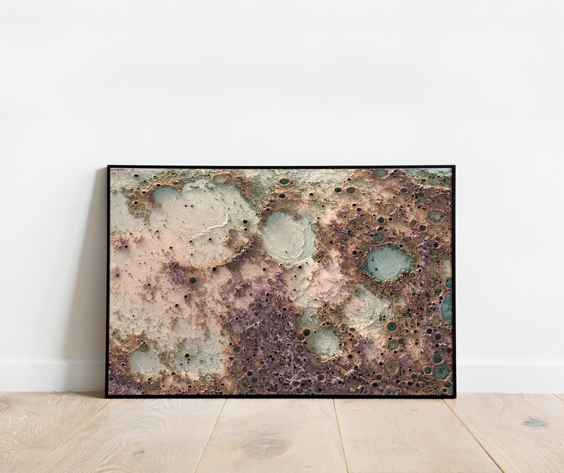 May include: Abstract art print featuring a textured, mottled surface with shades of pink, brown, green, and white. The surface resembles a close-up of the moon's surface.