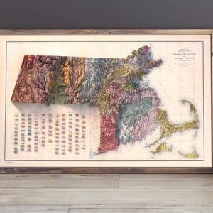 May include: A vintage map of the state of Massachusetts, showing the different geological formations in a colorful relief style. The map is framed in a wooden frame and has a white background.