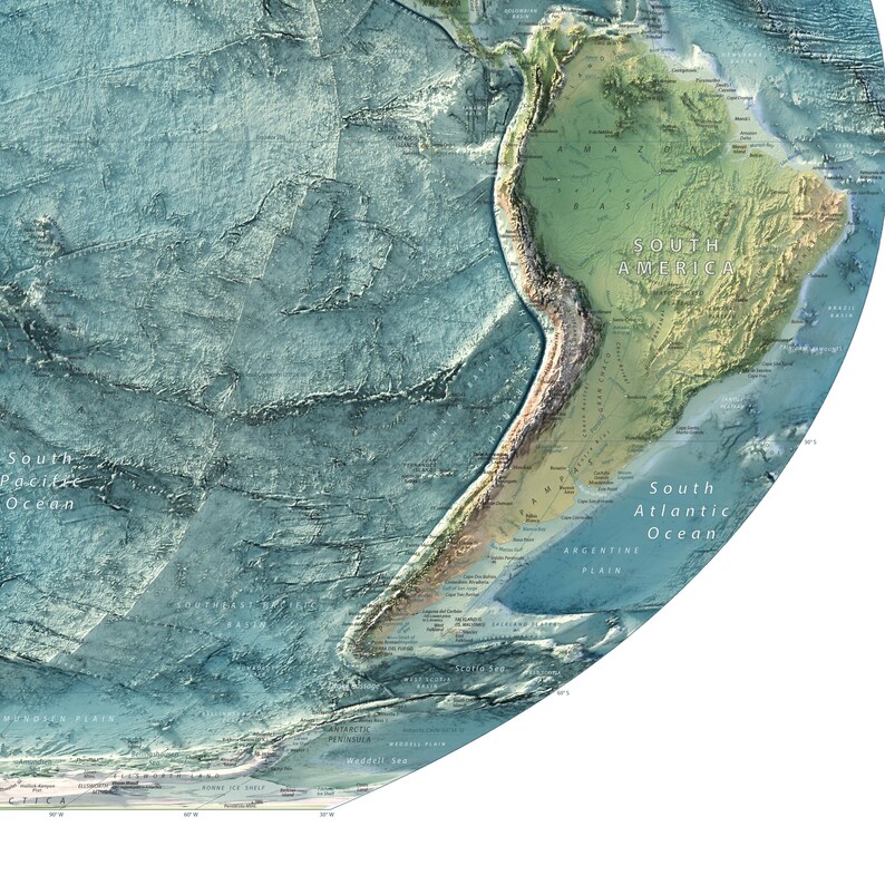 May include: A circular physical map showing the topography of South America and the surrounding ocean floor. The land is rendered in shades of green and brown, while the ocean floor features blue, textured bathymetric relief details.