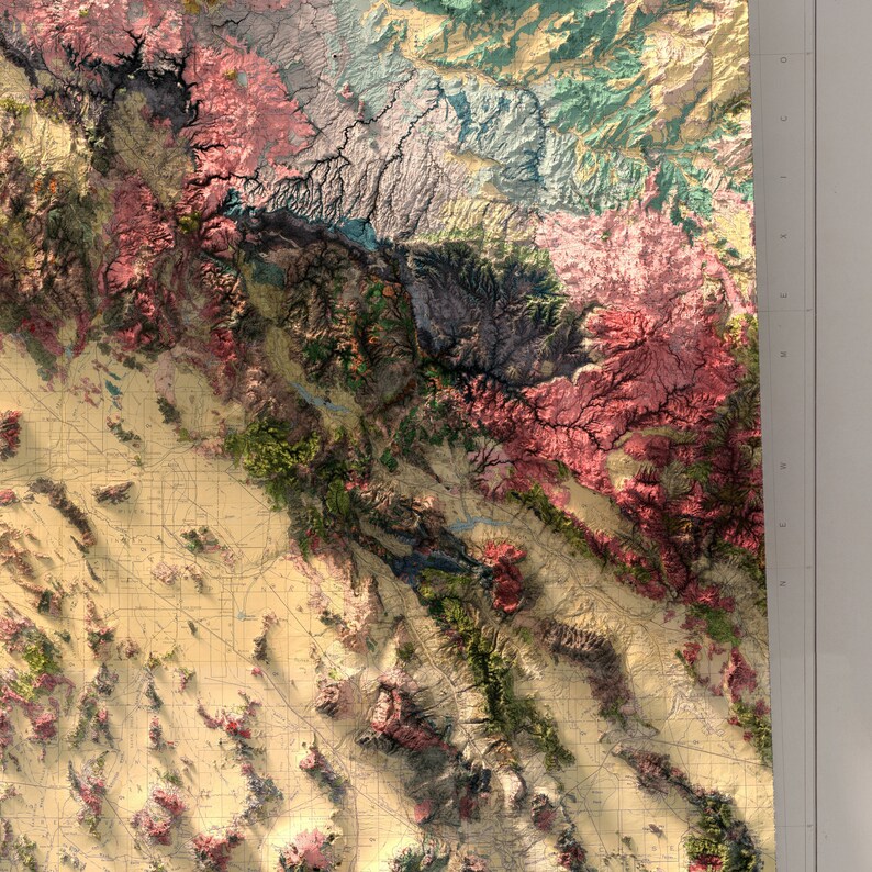 May include: A detailed topographic map of a mountainous region with various shades of green, blue, pink, and brown. The map shows elevation changes and features like rivers and valleys.