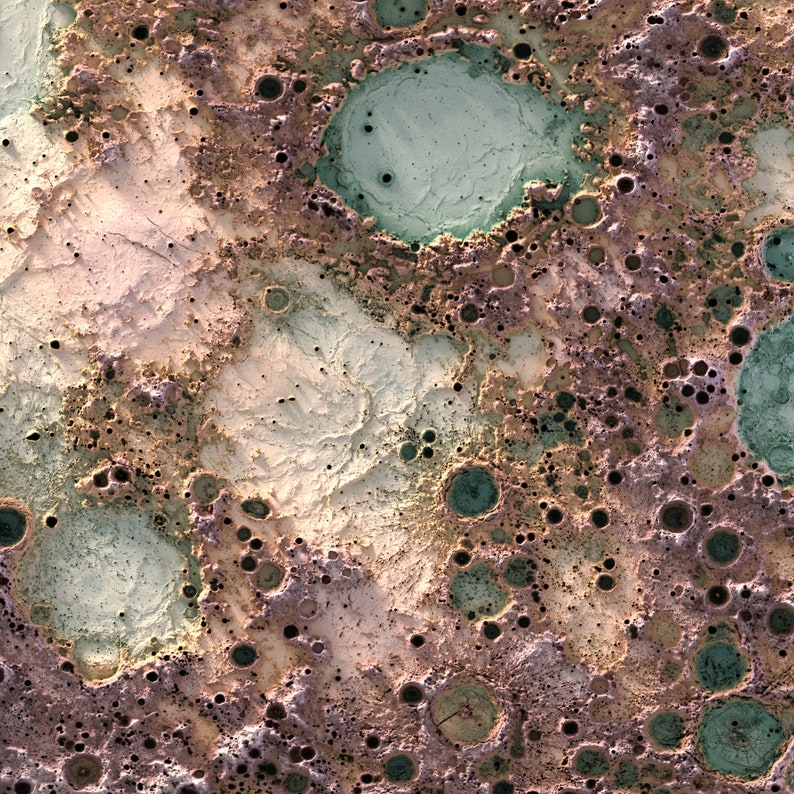 May include: A close-up of a textured surface with a variety of craters and holes. The surface is a mix of brown, white, and green colors.