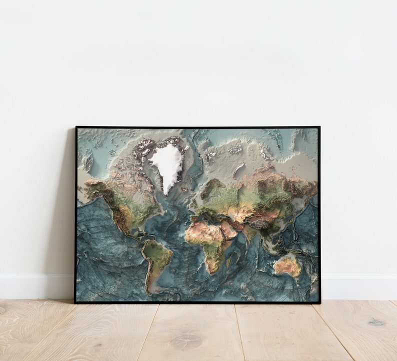 May include: A framed world map with a 3D effect, showing the continents in shades of green, brown, and blue. The map is framed in black and has a white background.