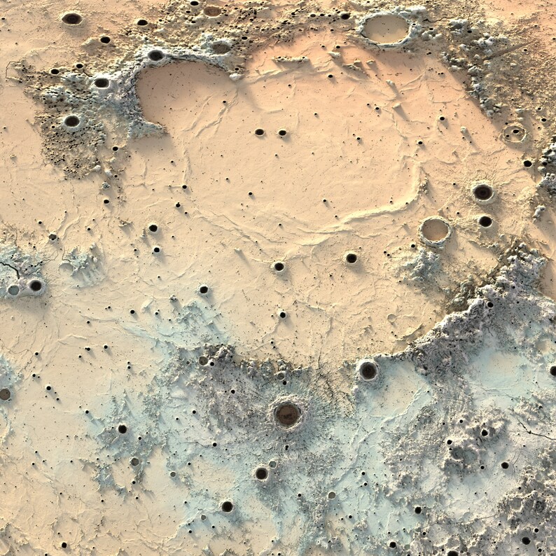 May include: A close-up of a textured surface with a light brown and blue color scheme. The surface is covered in small craters and crevices, resembling the surface of the moon.