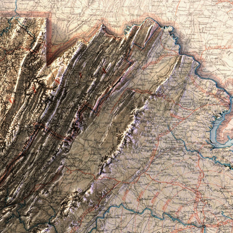May include: A detailed, vintage map of a mountainous region, likely a state or area in the United States. The map features shaded relief, highlighting the topography with brown and beige tones. Red lines indicate roads, and text labels identify cities and geographical features.