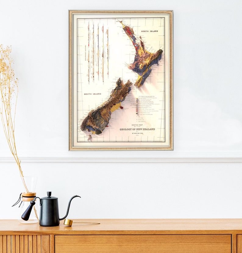 May include: A vintage map of the geology of New Zealand, printed in shades of brown, yellow, red, and blue. The map shows the North Island and South Island, with the text "Geology of New Zealand" printed at the bottom.