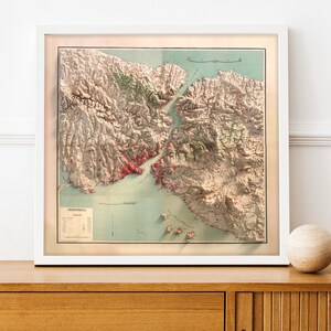 May include: A vintage map of the San Francisco Bay Area, printed in shades of brown, green, and red. The map shows the coastline, islands, and surrounding land. The title "San Francisco Bay" is printed at the top of the map.