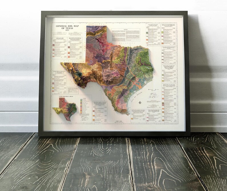 May include: A vintage map of Texas showing the general soil map of the state. The map is framed in a black frame and has a 3D effect. The map is titled "General Soil Map of Texas 1957".