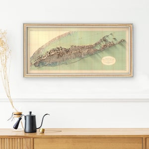 1913 Long Island Topographic Map in a cozy bedroom, creating a warm, nostalgic atmosphere with its detailed vintage design.