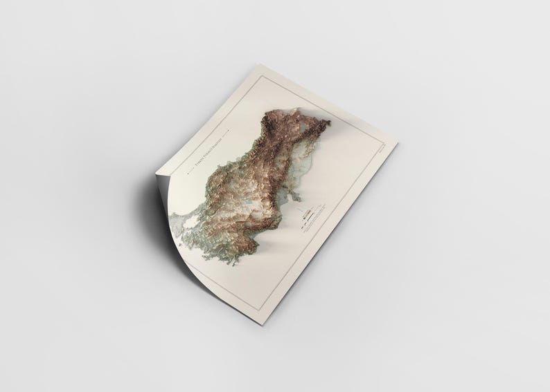 May include: A detailed, textured map of Europe with a 3D effect, printed on a white paper background. The map is folded in the upper left corner.