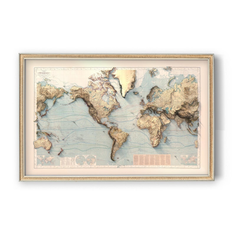 May include: A framed world map print featuring a raised relief style depiction of continents in shades of gold and tan against a pale blue ocean background. The map includes detailed topographical textures, thin blue latitude lines, and text blocks.