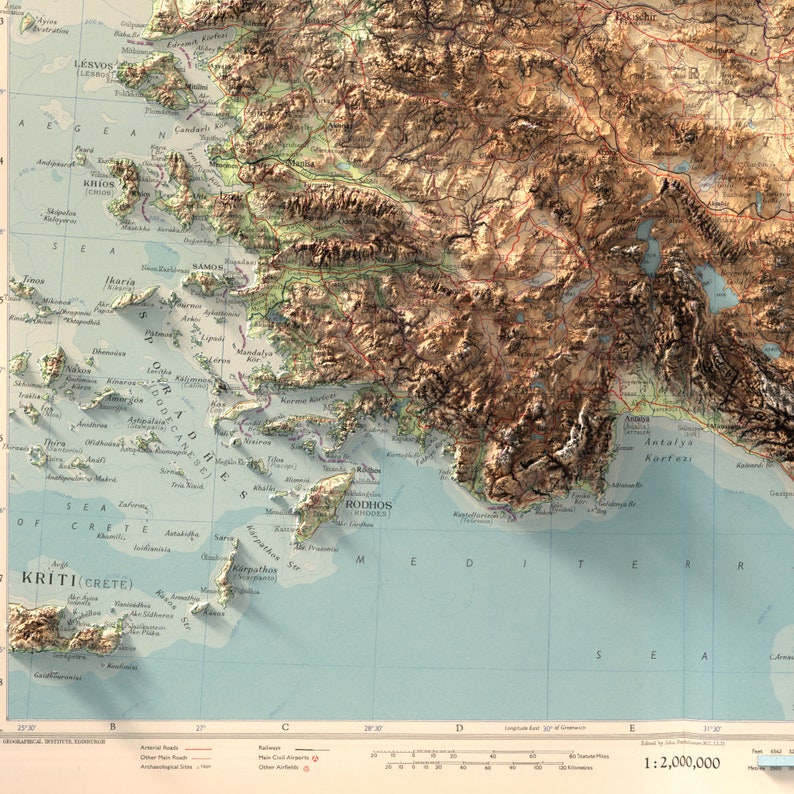 May include: A detailed topographic map of Greece and surrounding islands, including Crete and Rhodes. The map features a color-coded elevation system, with brown representing higher elevations and blue representing water. The map also includes various geographical features, such as rivers, lakes, and mountains. The map is titled "1:2,000,000" in the bottom right corner.