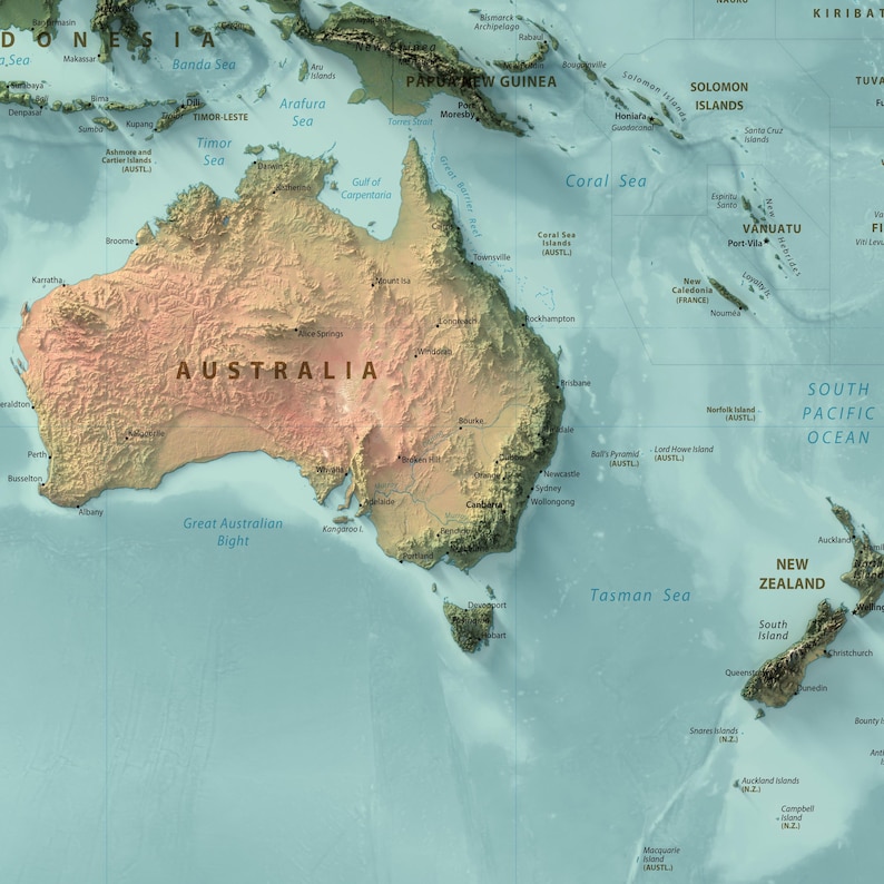 May include: A physical map of Australia and New Zealand featuring a relief-style terrain with tan and brown landmasses contrasted against a light blue ocean. The map includes labels for major cities, regions, and surrounding seas in English.
