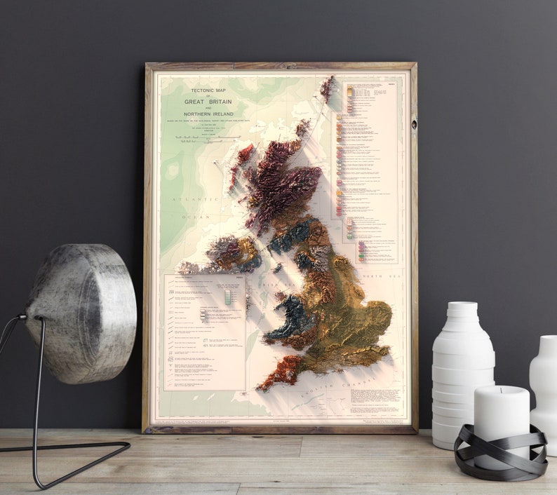May include: A vintage-style map of Great Britain and Northern Ireland, showing the tectonic map of the region. The map is printed on a cream-colored paper and framed in a brown wood frame.