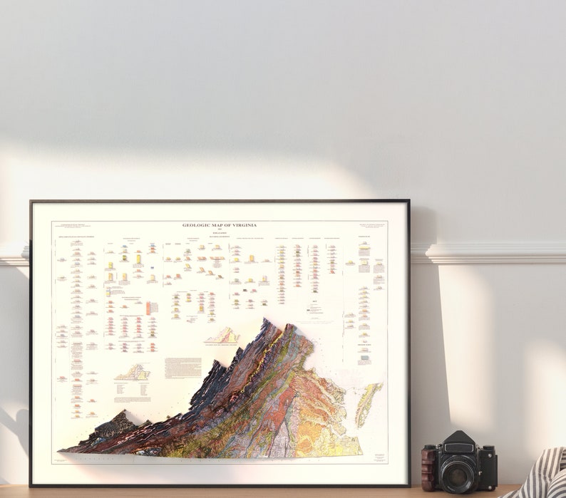 May include: A framed geological map of Virginia, showing the state's diverse rock formations and geological history. The map is in a black frame and features a detailed color-coded key.