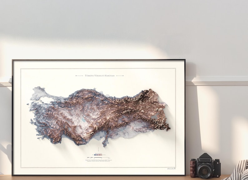 May include: A framed map of Turkey with a 3D relief effect, showing the country's topography in shades of brown and white. The title "T&uuml;rkiye Y&uuml;kseklik Haritası" is printed at the top of the map.