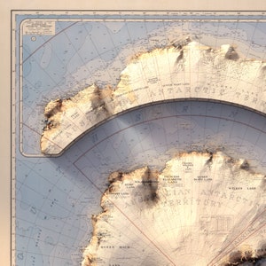 May include: A vintage map of Antarctica, showing detailed topography and land features. The map is printed on a light blue background with brown and red lines. The map shows the names of various land masses, including Queen Mary Land, Wilkes Land, and Princess Elizabeth Land.