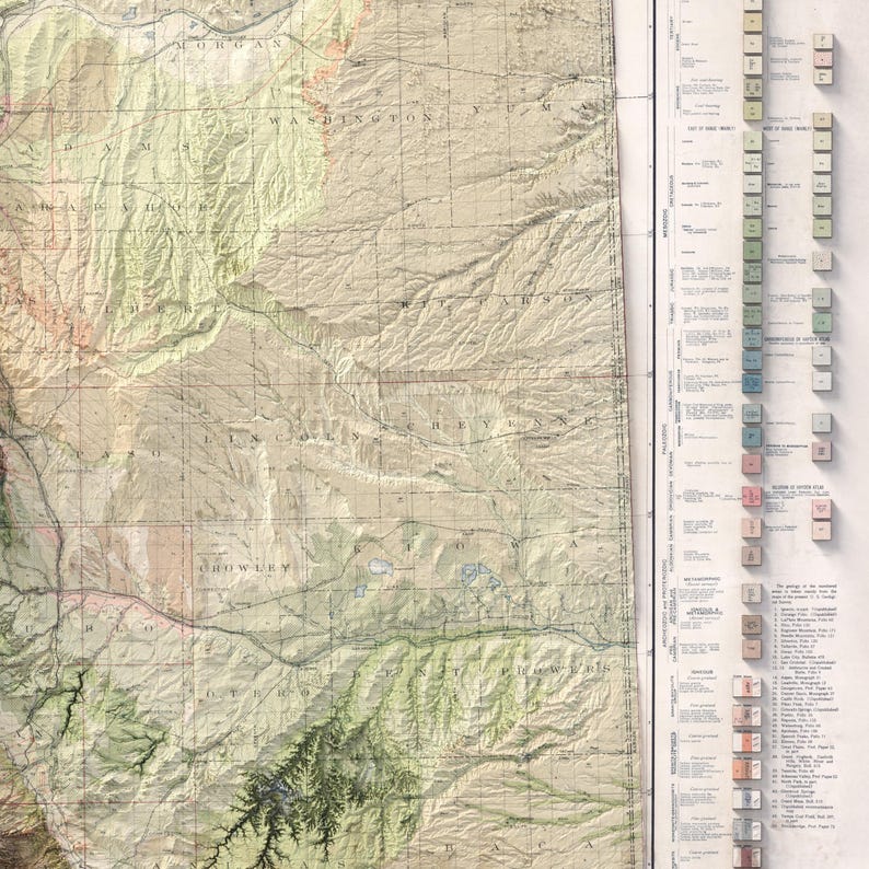 May include: A detailed topographic map with a vintage aesthetic. The map features shaded relief, contour lines, and place names. The color palette includes shades of green, brown, and beige, with a key and legend along the right side.