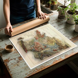 May include: A detailed, vintage-style map with raised relief, showcasing a geographical region with various colors. The map is on a white background, and a brown tube is next to it. The map is on a distressed wooden table.