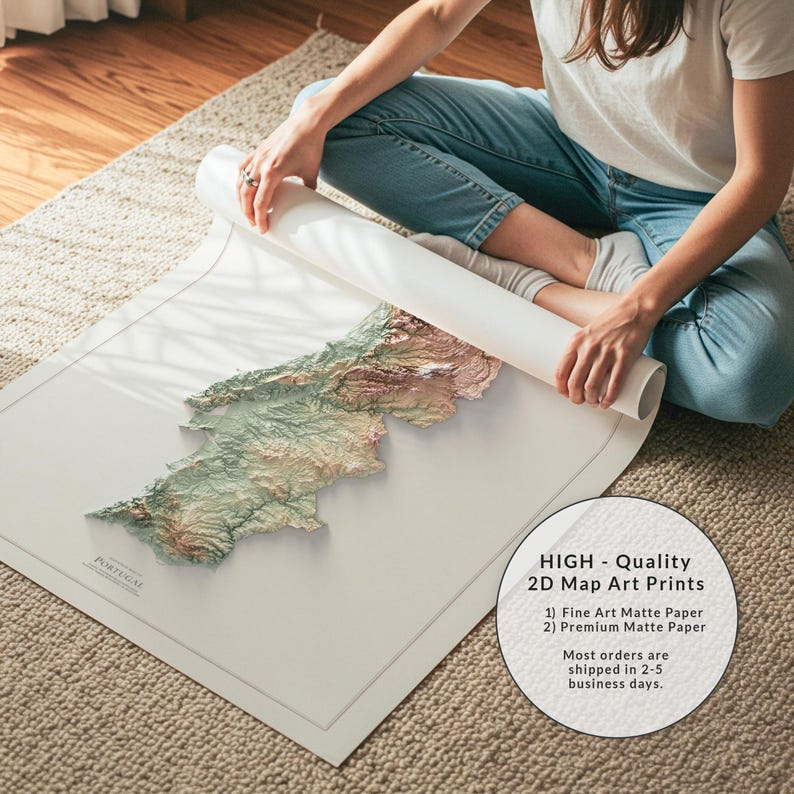 May include: A detailed 3D map art print of Portugal, featuring topographical details in shades of green, brown, and beige. The map is on a white matte paper, being unrolled by a person. The print is labeled "PORTUGAL".