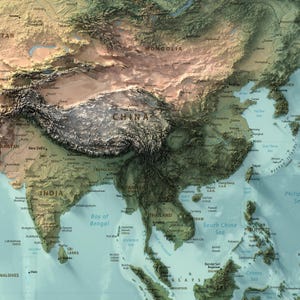May include: A physical map of East and Southeast Asia featuring a relief-style design. The terrain displays varied elevations in shades of green, brown, and tan, with labeled countries, cities, and bodies of water including China, India, and the South China Sea.