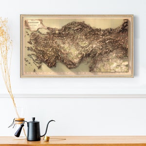 May include: A vintage, framed map of Turkey with a 3D relief effect. The map is printed on a cream-colored paper with brown and green tones. The title "KARTE KLEINASIEN" is printed at the top of the map.